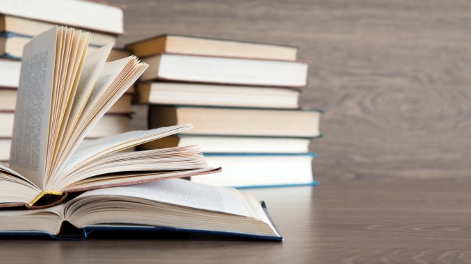 books on wooden deck tabletop