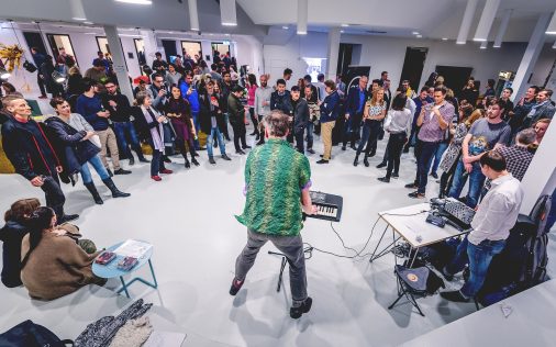 Space Shack opening event, man playing keyboard to crowd