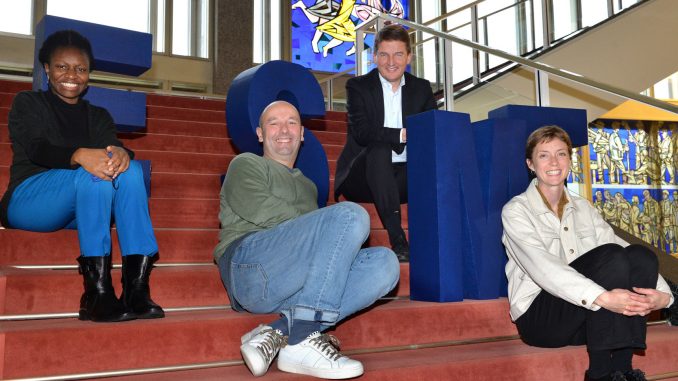 Duroseme Taylor, Harald Panzer, Jörg Rocholl and Claire Duggan sitting on stairs at ESMT Berlin