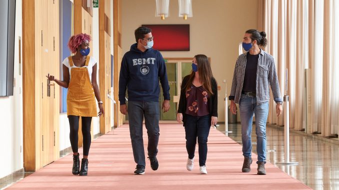 MBA students walking together with masks on