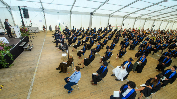 MIM graduates sitting at graduation ceremony