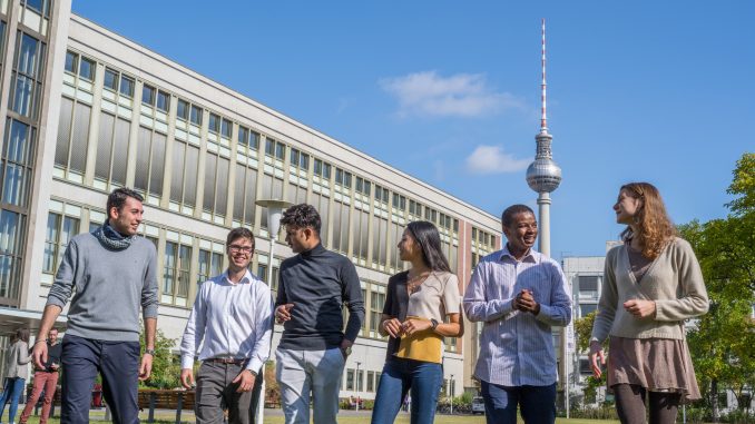 students walking in ESMT garden with TV Twoer in background