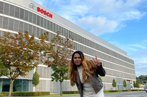 student posing in front of Bosch building