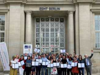 ETP participants holding certificate in front of ESMT Berlin building