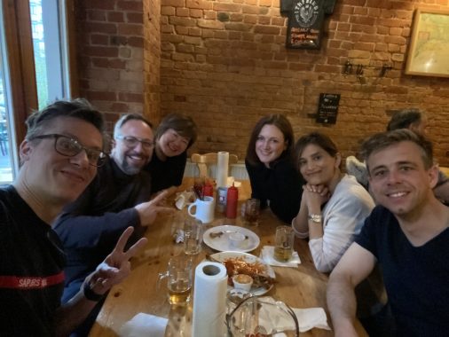 6 EMBA students posing for a selfie at a restaurant