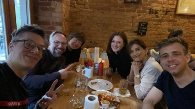 6 EMBA students posing for selfie at restaurant