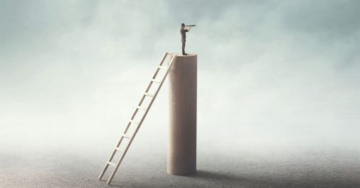 man standing on tower looking out into the horizon