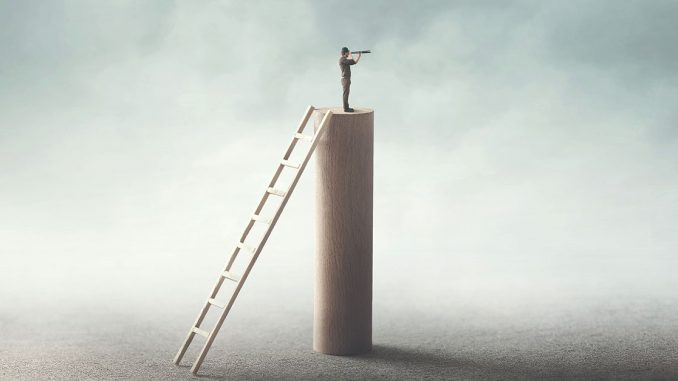 man standing on tower looking out into the horizon