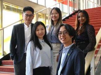 5 MBA students posing on ESMT stairs for group photo
