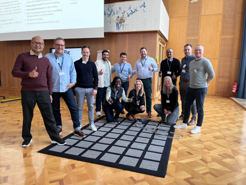 Group of Digital Transformation posing for photo on interactive mat. 